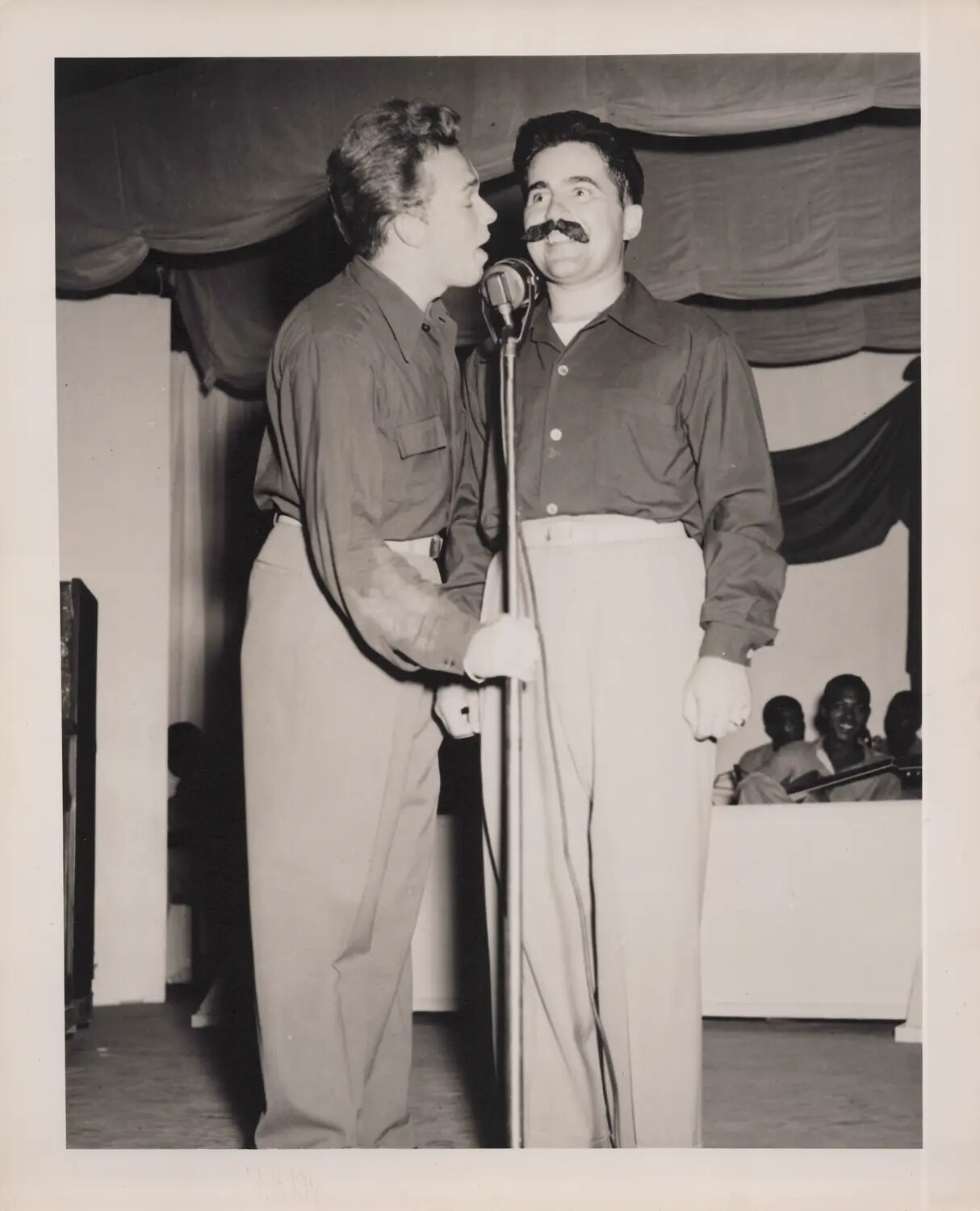 Comedic Duet Performance with False Mustache During Servicemen's Variety Show, WWII Era