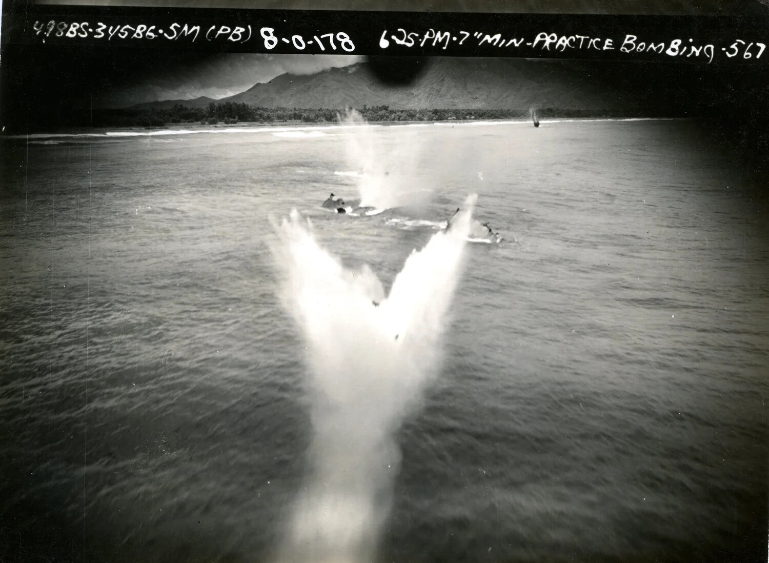 345th Bombardment Group Practice Bombing Run - Close Bomb Splash Near Target Hulk