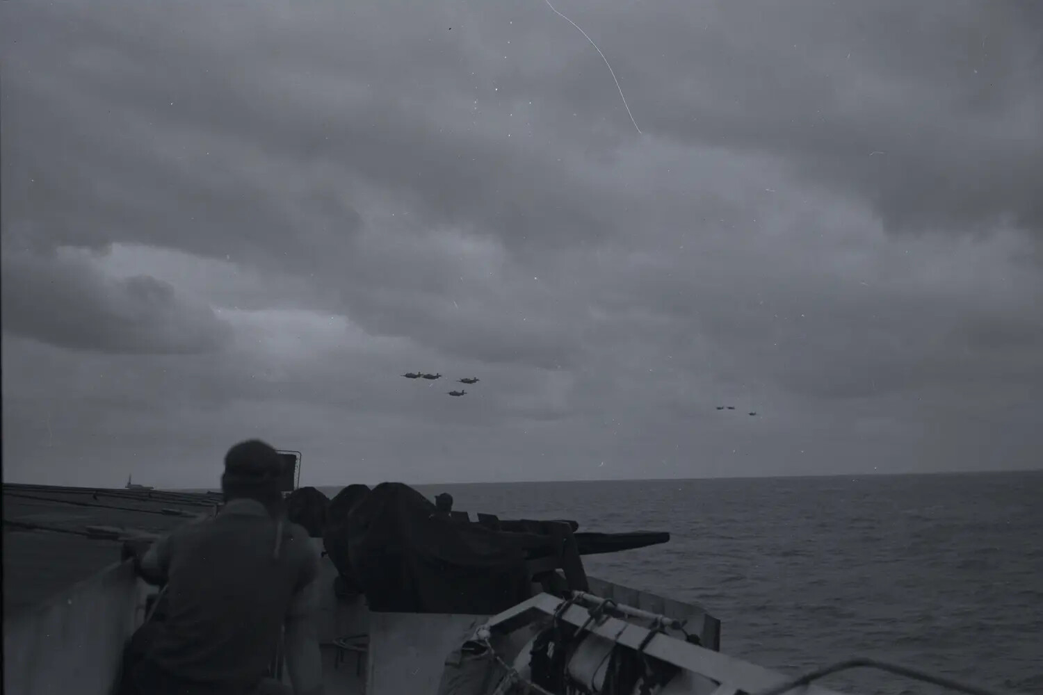 Sailor at Anti-Aircraft Gun Watches Aircraft Formation from USS Petrof Bay (CVE-80), WWII