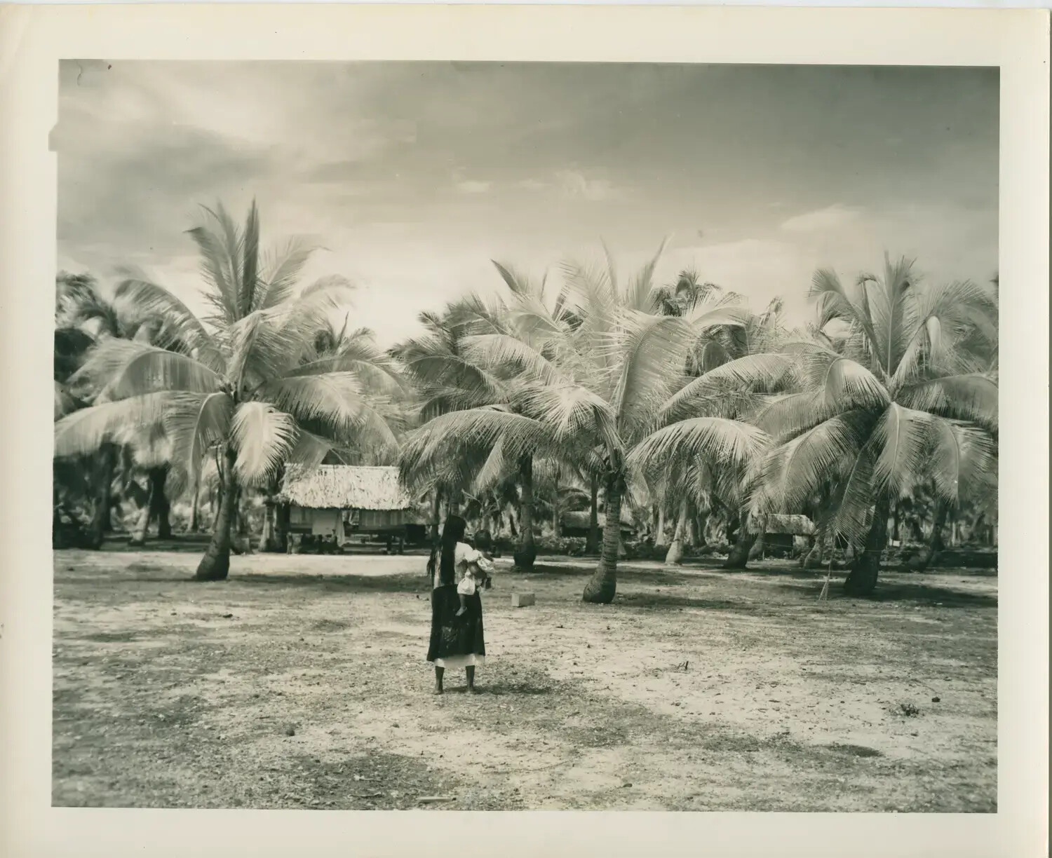 Local Woman and Child Among Coconut Palms, Pacific Island Village — USS Petrof Bay (CVE-80) Collection, WWII