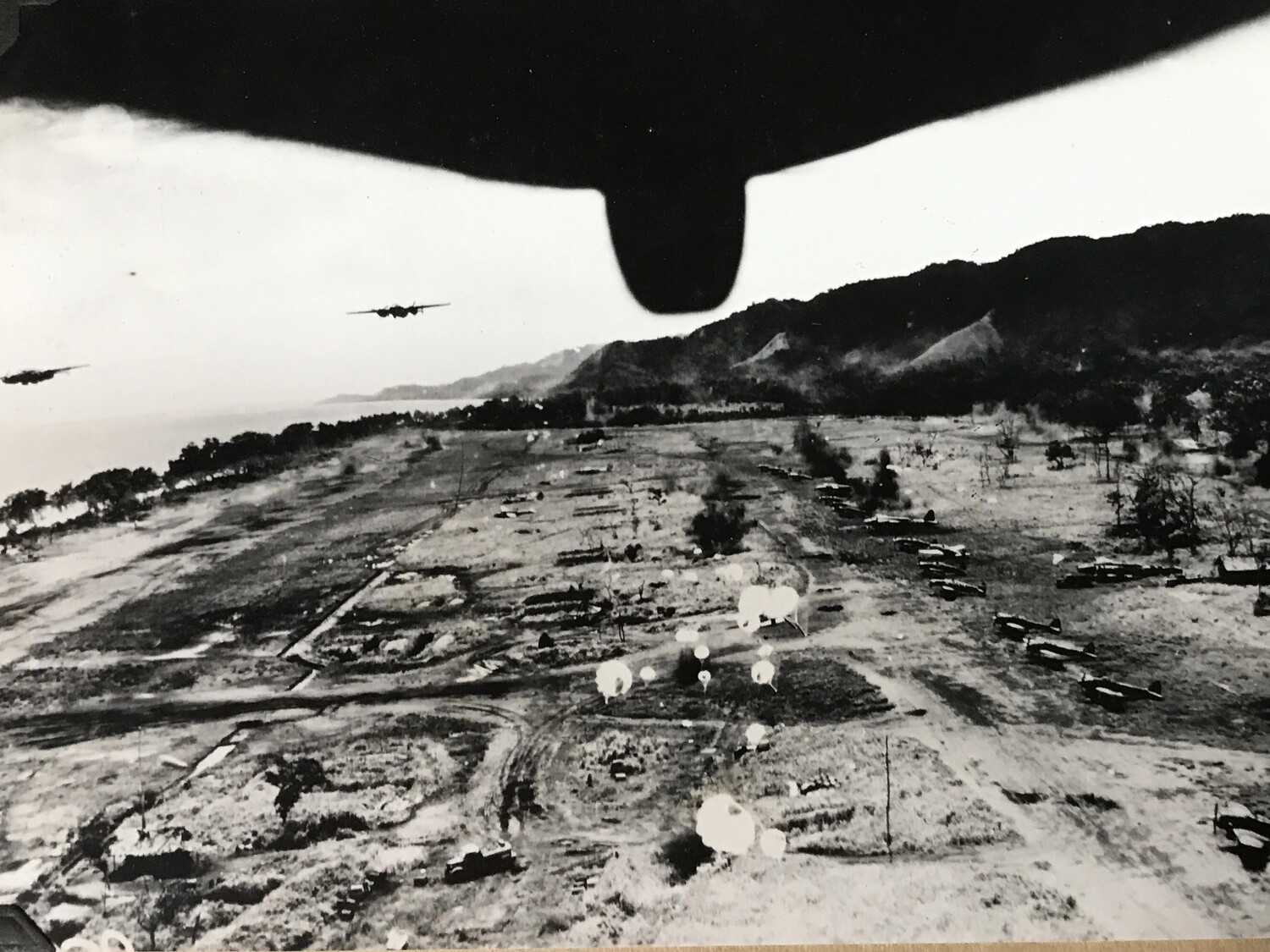 B-25 Mitchell Formation Dropping Parafrag Bombs on Japanese Airfield, New Guinea