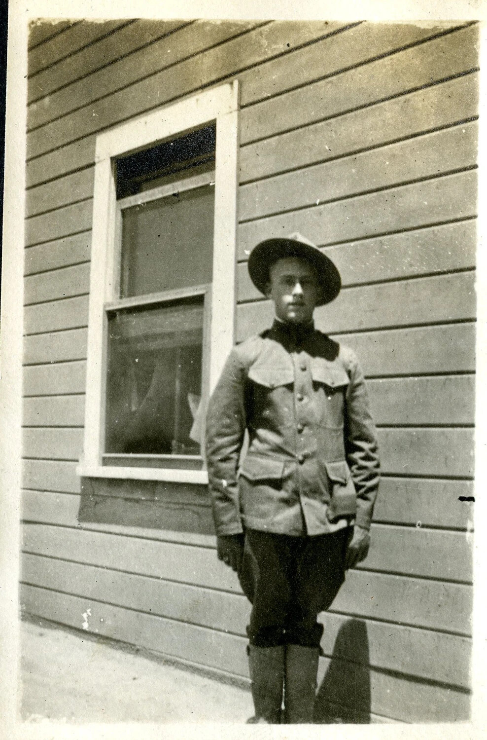 U.S. Army Soldier Standing Beside Barracks Window, WWI Era, c. 1917-1918