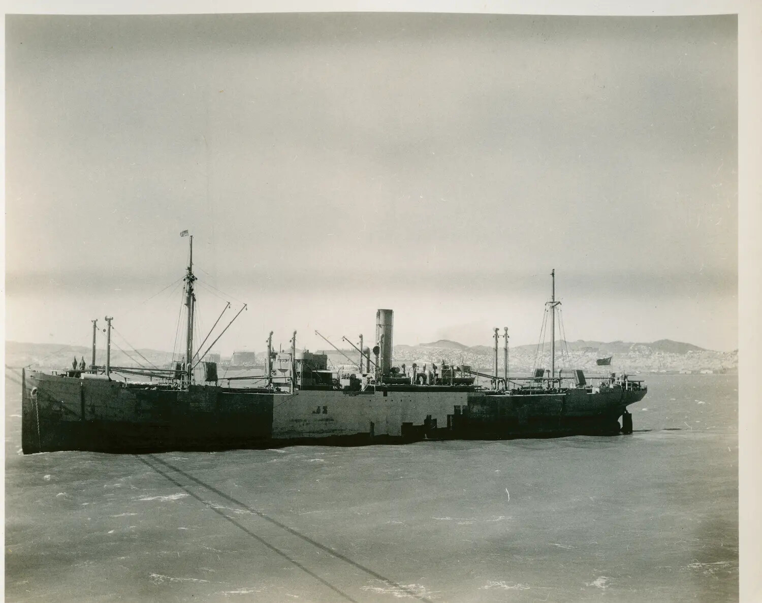 Merchant Steamer at Anchor in Harbor, Viewed from USS Petrof Bay (CVE-80)