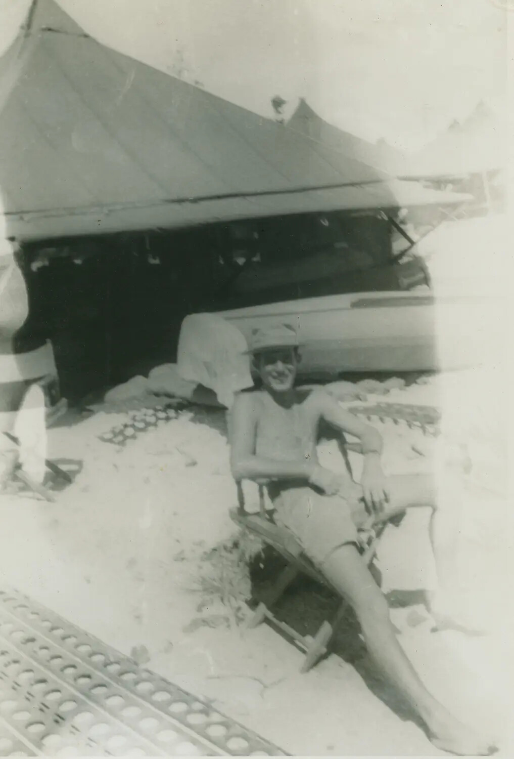 Serviceman Relaxing on Marston Mat-Covered Airfield Beach, WWII Pacific Theater (Illustrative)