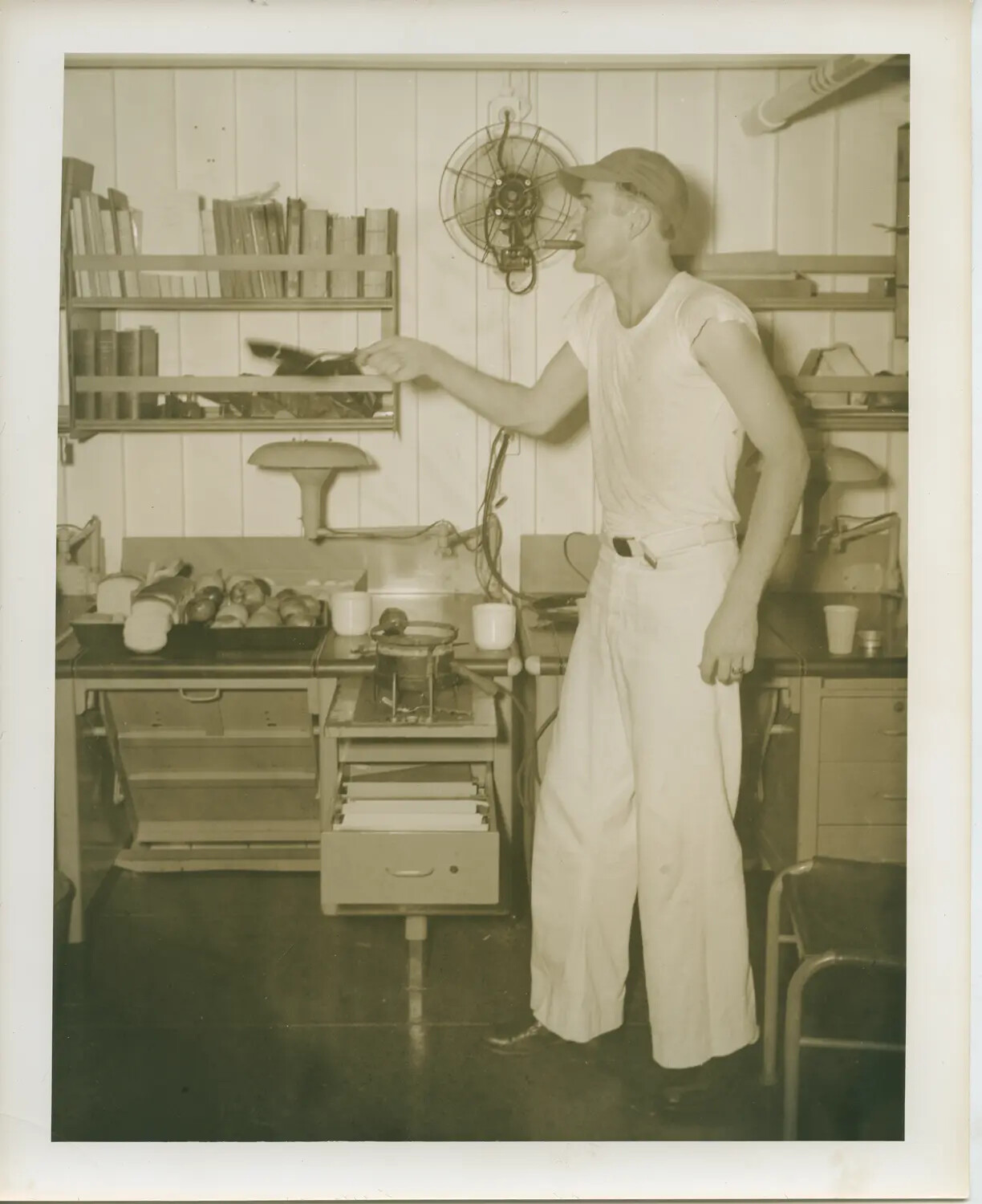 Sailor at Work in Shipboard Compartment Aboard USS Petrof Bay (CVE-80)