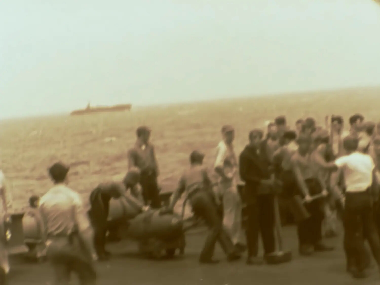 U.S. Navy Sailors on Deck with Stretcher/Cargo Bundle, Pacific Theater, WWII (Francis R. Ferry Film Collection, Frame 020)