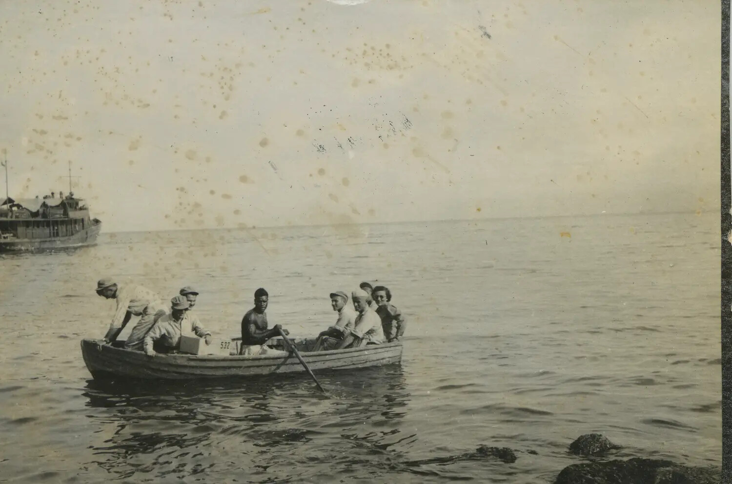 Servicemen and Civilian Woman Ferried by Local Boatman in Numbered Rowboat