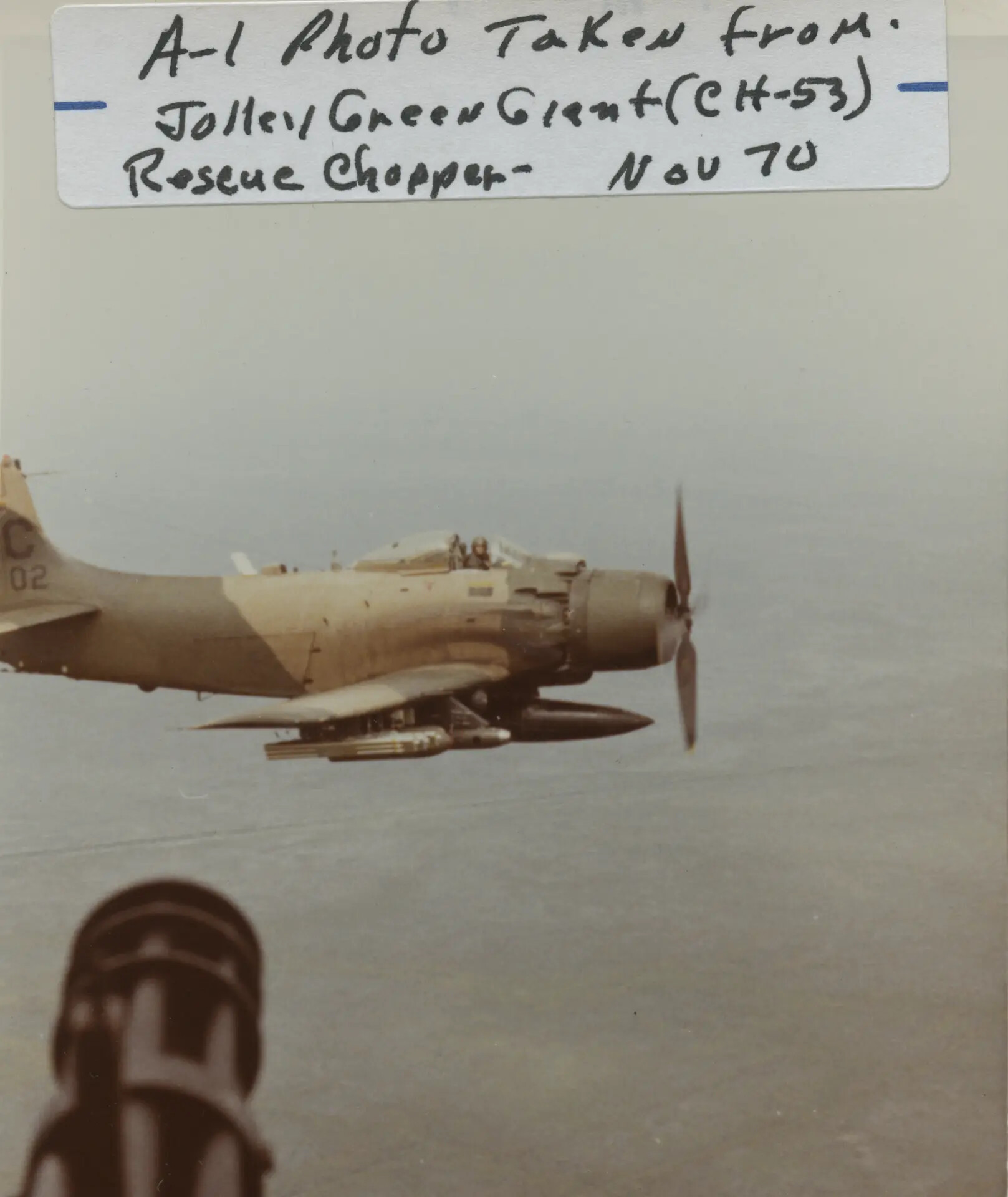 Raw Scan: A-1 Skyraider Escort Aircraft Photographed from CH-53 Jolly Green Giant Rescue Helicopter, November 1970