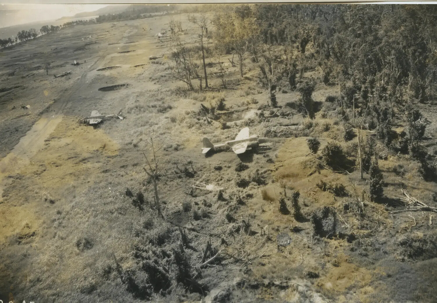 Aerial Reconnaissance Photograph of Destroyed Japanese Aircraft on Coastal Airstrip, Southwest Pacific Theater, World War II