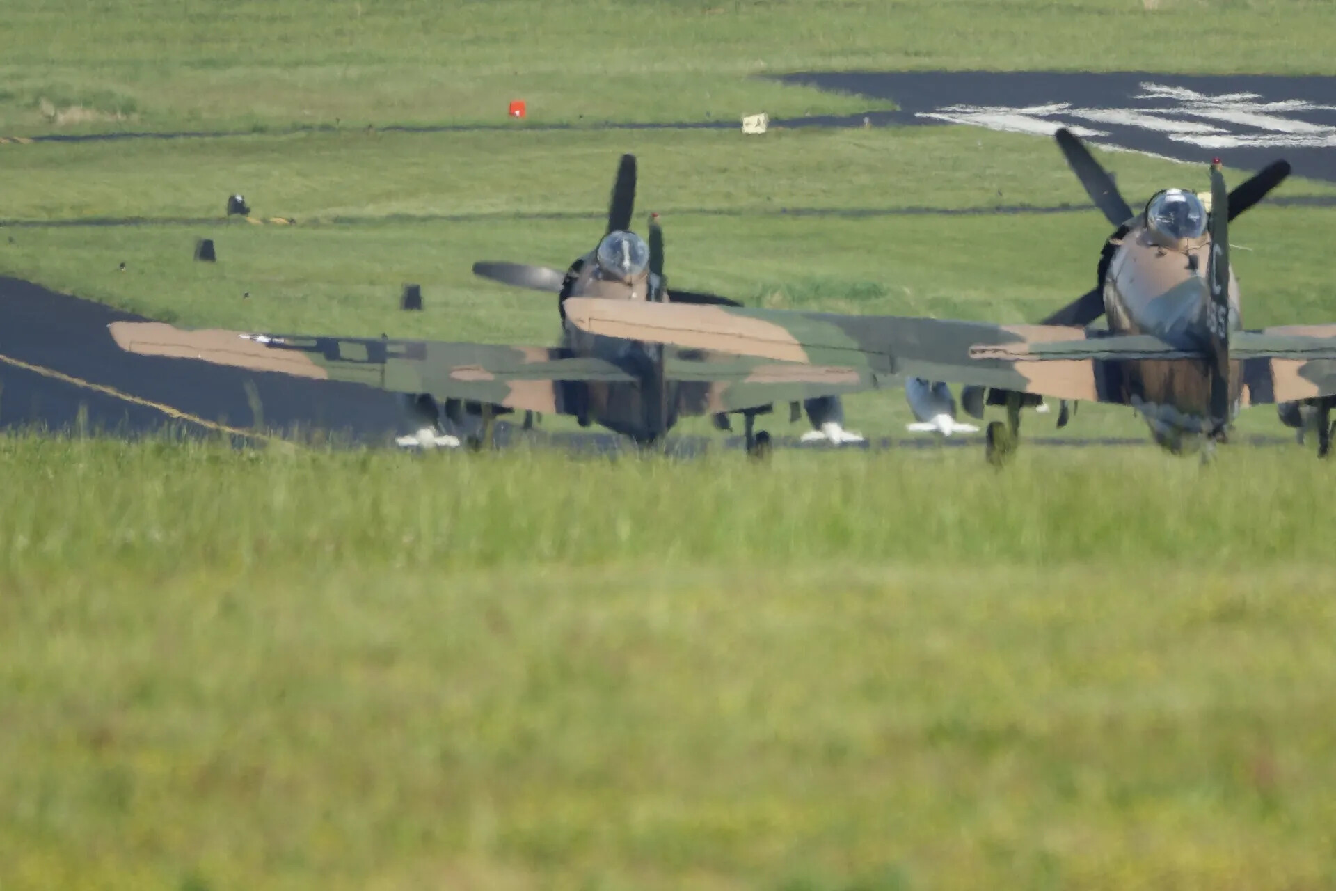 Two Camouflaged Douglas A-1 Skyraiders Taxiing at Close Range, May 2019 Reunion Event
