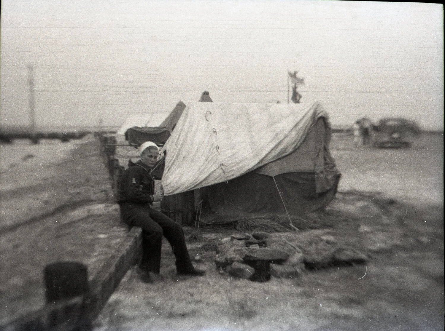 Sailor-Uniformed Youth Beside Beach Tent Encampment, State-Side, WWII Era