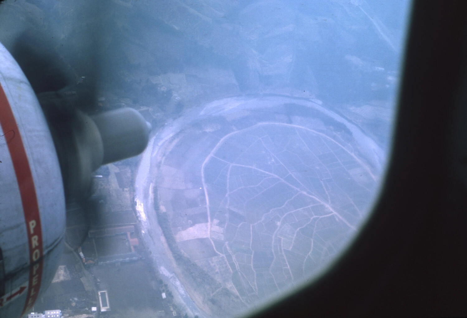 Aerial View from Propeller Aircraft Window Over Terraced Vietnamese Terrain, Vietnam War Era
