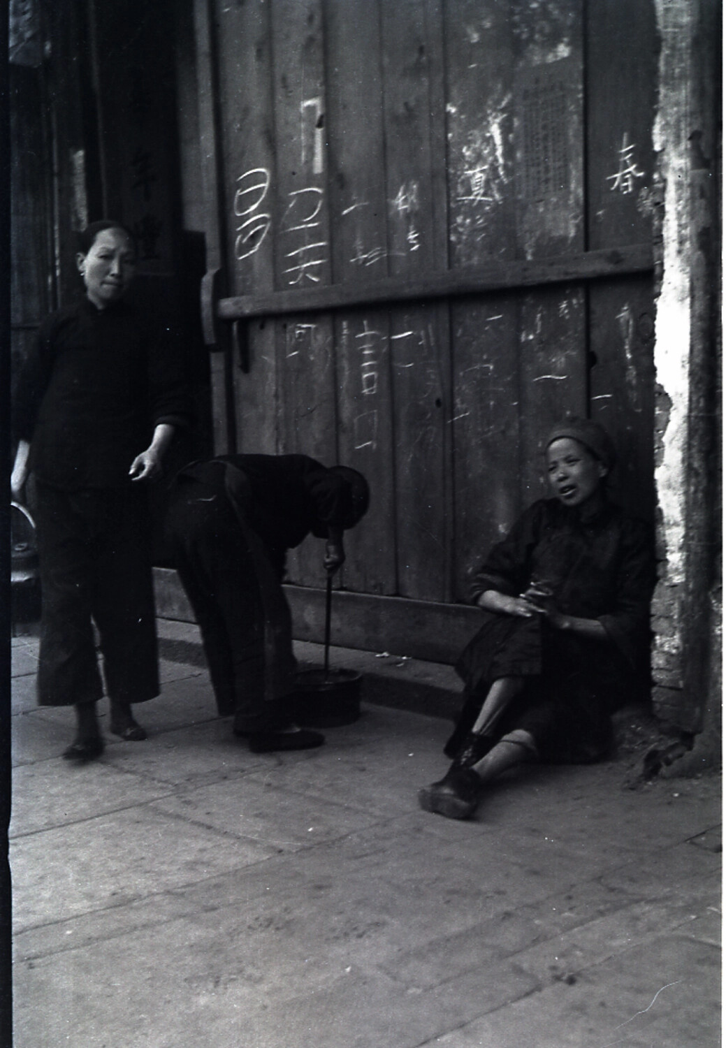Street Scene with Women and Inscribed Wooden Door, China, circa Late 1930s-1940s