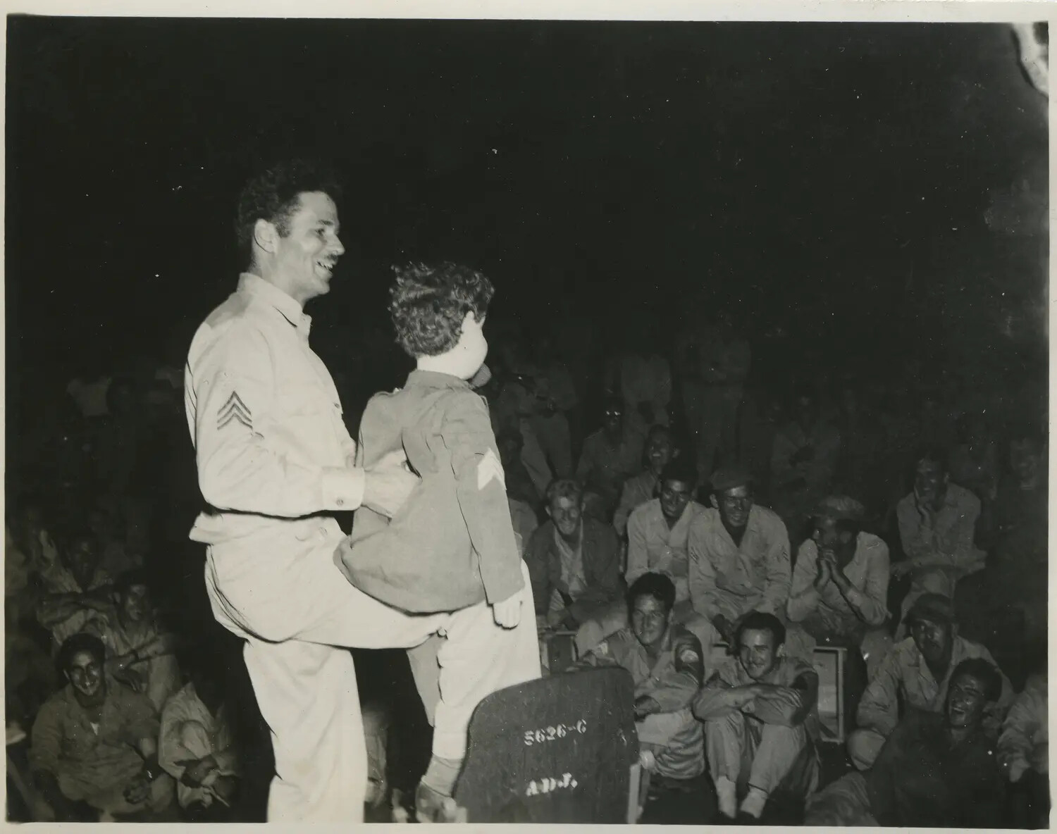 GI Entertainer and Child Mascot Perform Comedy Routine for Troops, 312th Bombardment Group, Pacific Theater, WWII