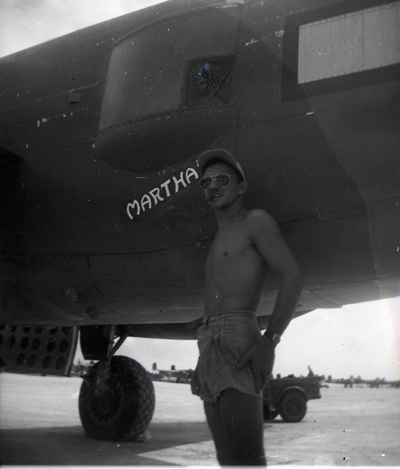 Airman Posing Beneath Nose Art 'MARTHA' on B-25 Mitchell Bomber, Ie Shima