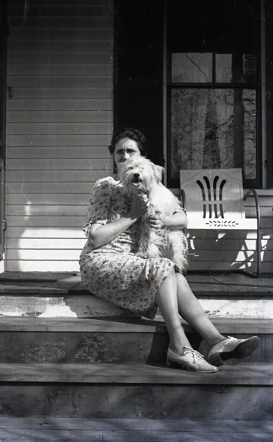 Woman with Pet Terrier on a Residential Porch Step, Stateside, WWII Era