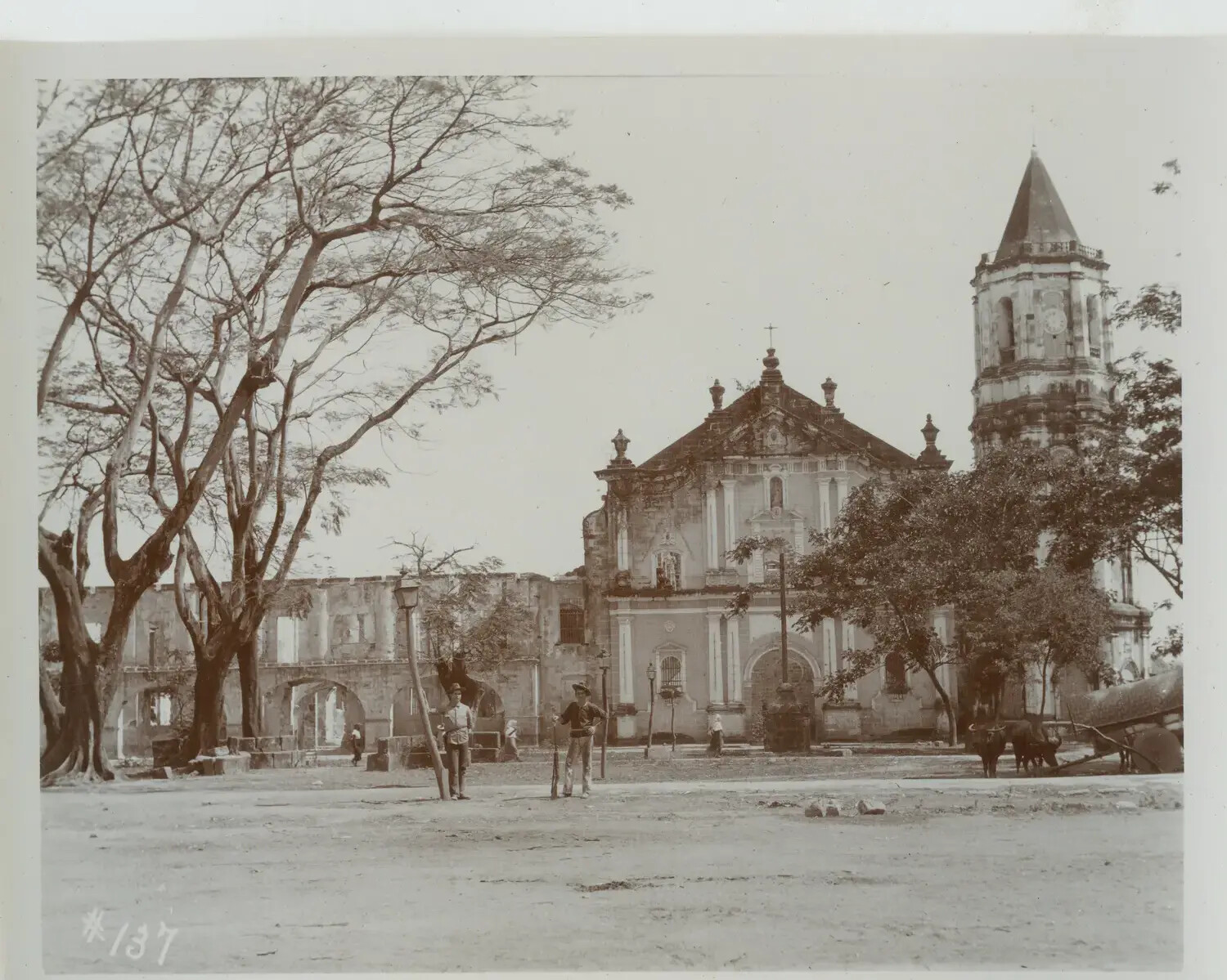 Plaza View of Stone Church with Bell Tower and Ruined Arcade, Philippines, c. 1890s