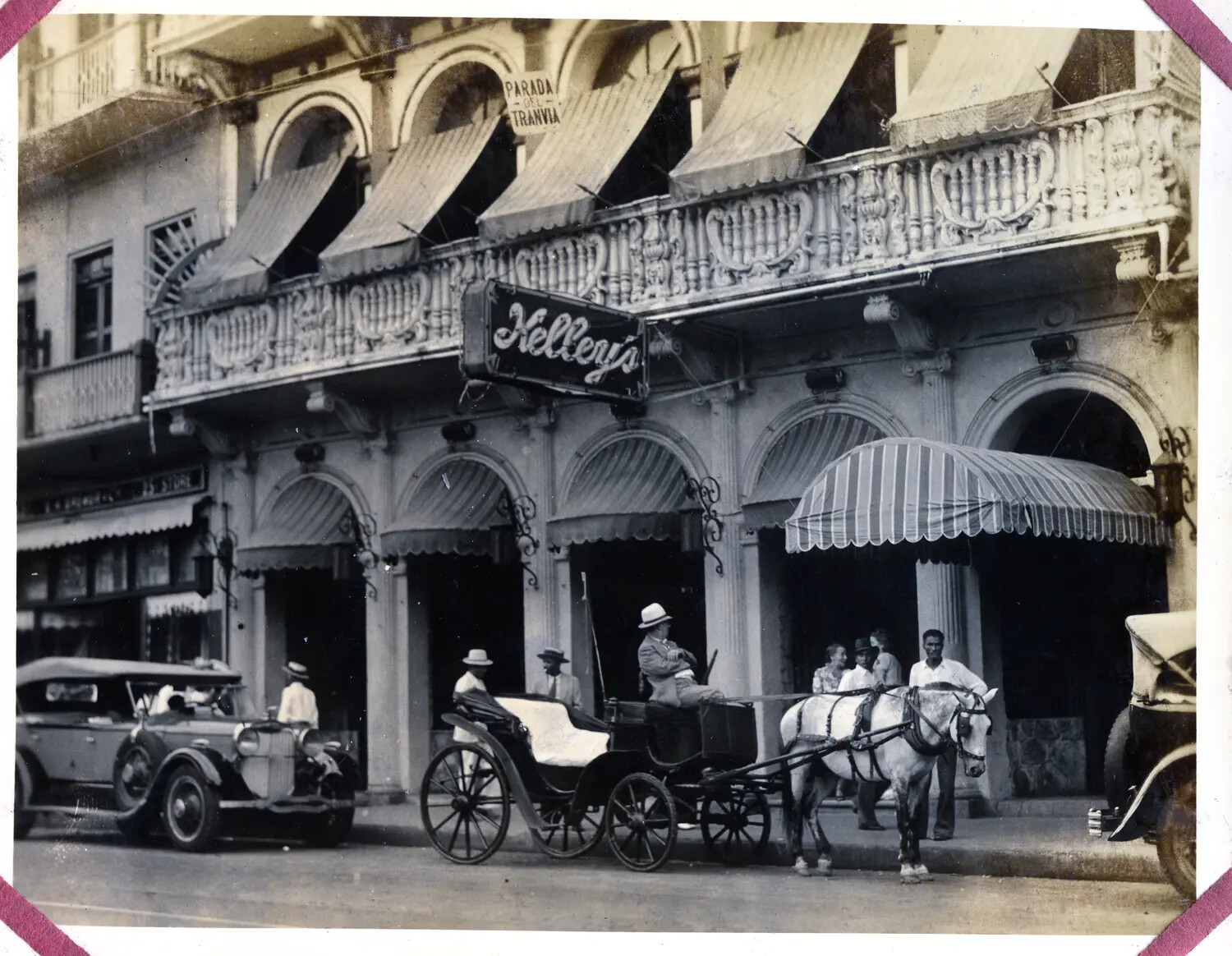 Street Scene with Horse-Drawn Carriage and Automobiles Outside Kelley's, Panama City