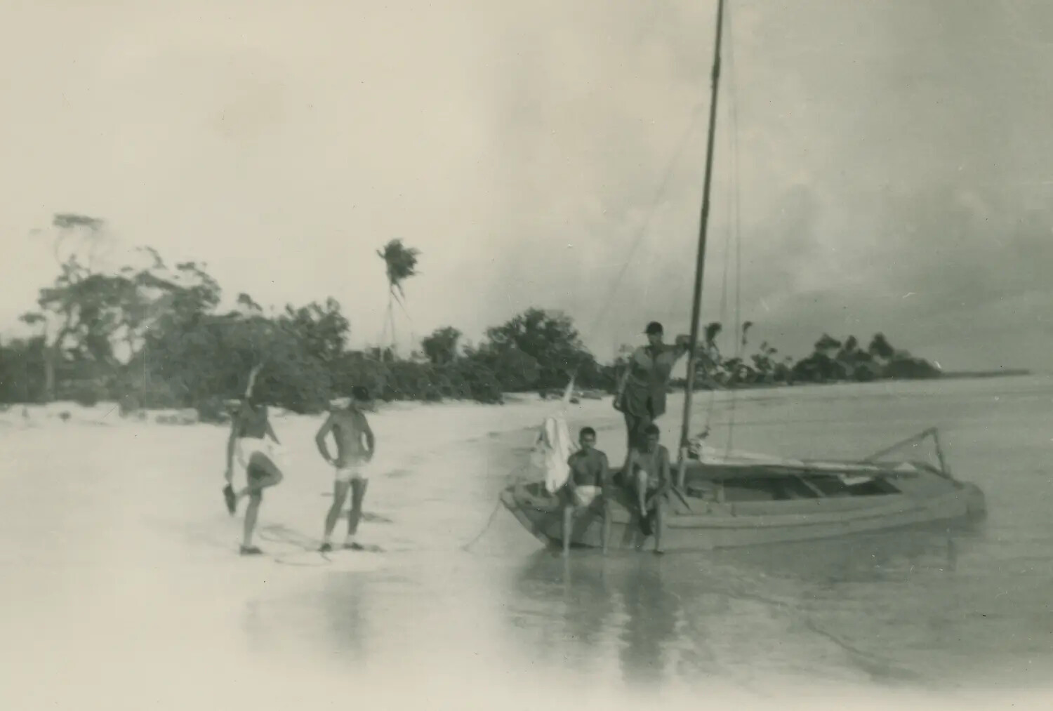 Servicemen with Outrigger Sailing Canoe on Tropical Beach, South Pacific, WWII