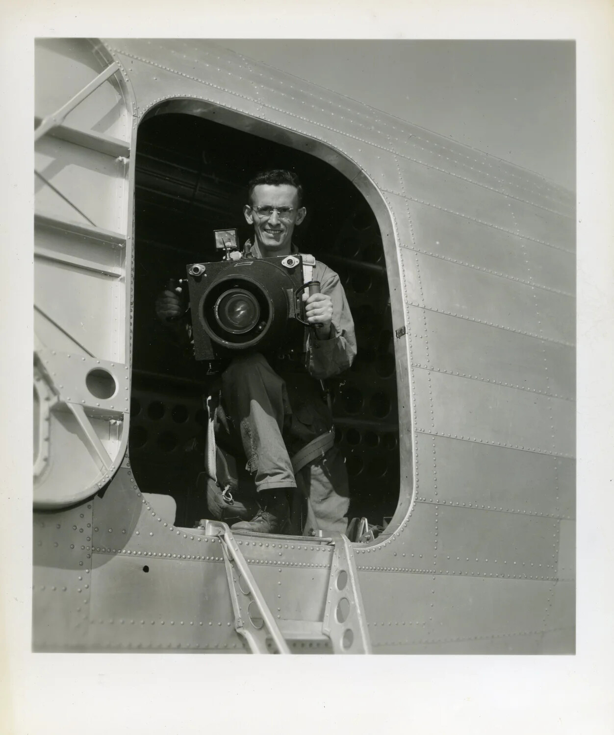 Airman Demonstrating Aerial Reconnaissance Camera in Aircraft Fuselage Hatch, CBI Theater