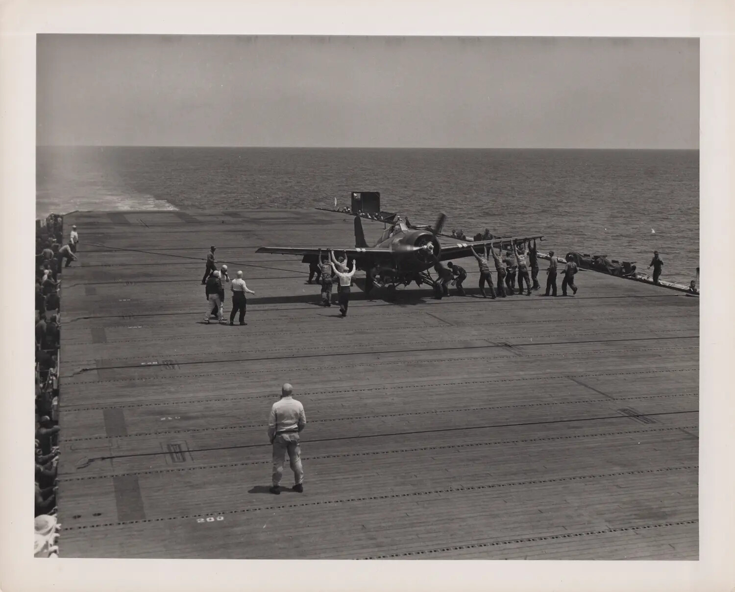 Deck Crew Respotting Fighter Aircraft on Escort Carrier Flight Deck, World War II