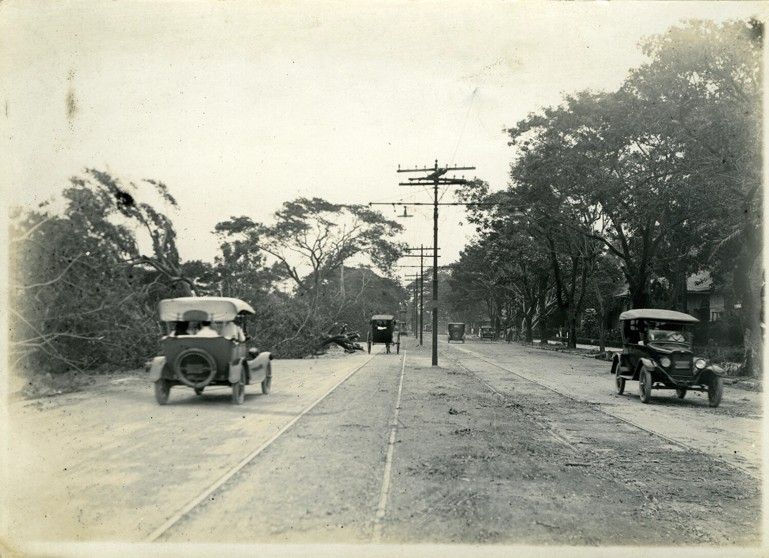 Storm-Damaged Boulevard with Automobiles and Calesa, Philippines, Early 1900s