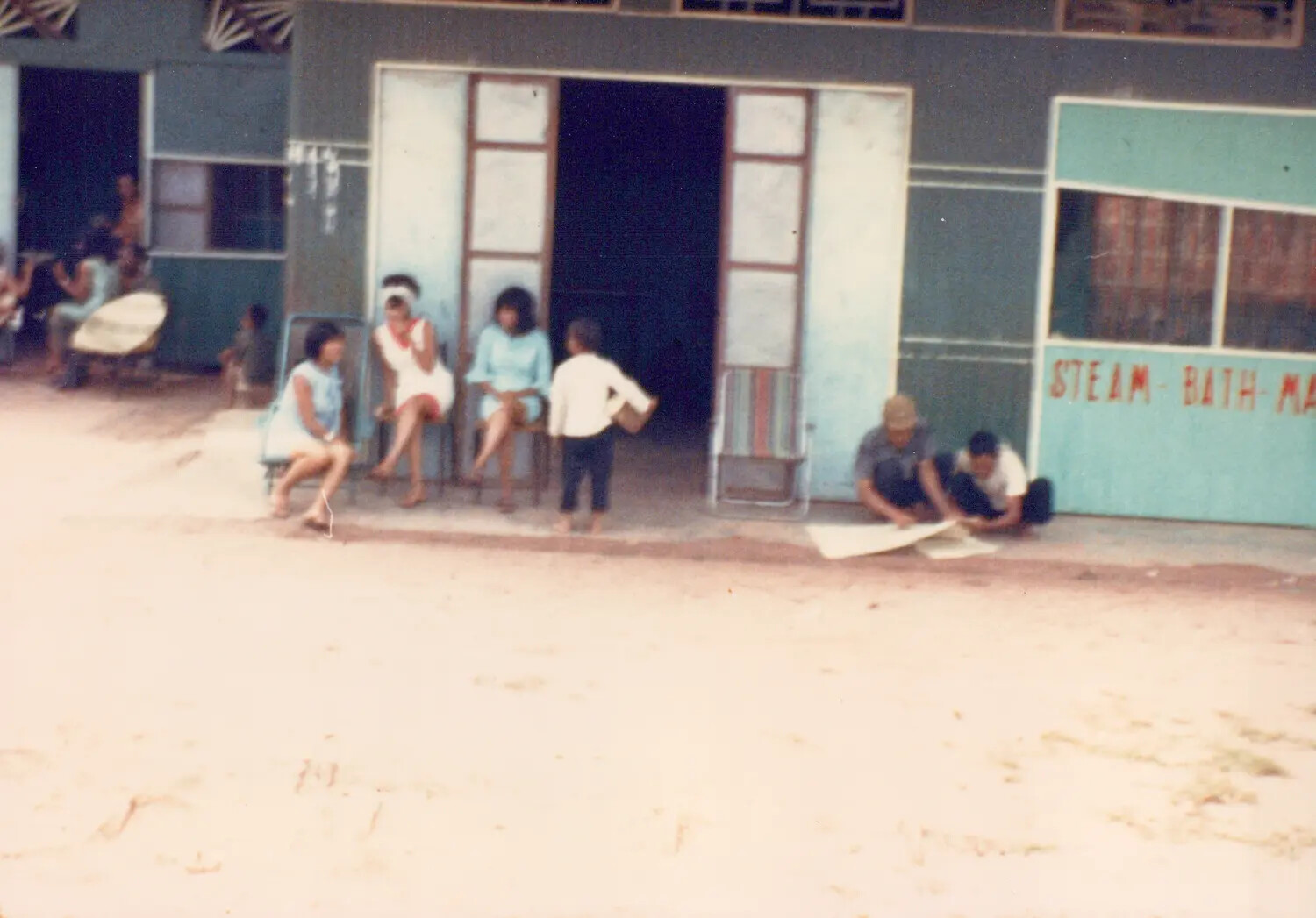 Street Scene Outside a "Steam Bath - Massage" Storefront, Cu Chi, South Vietnam, 1967