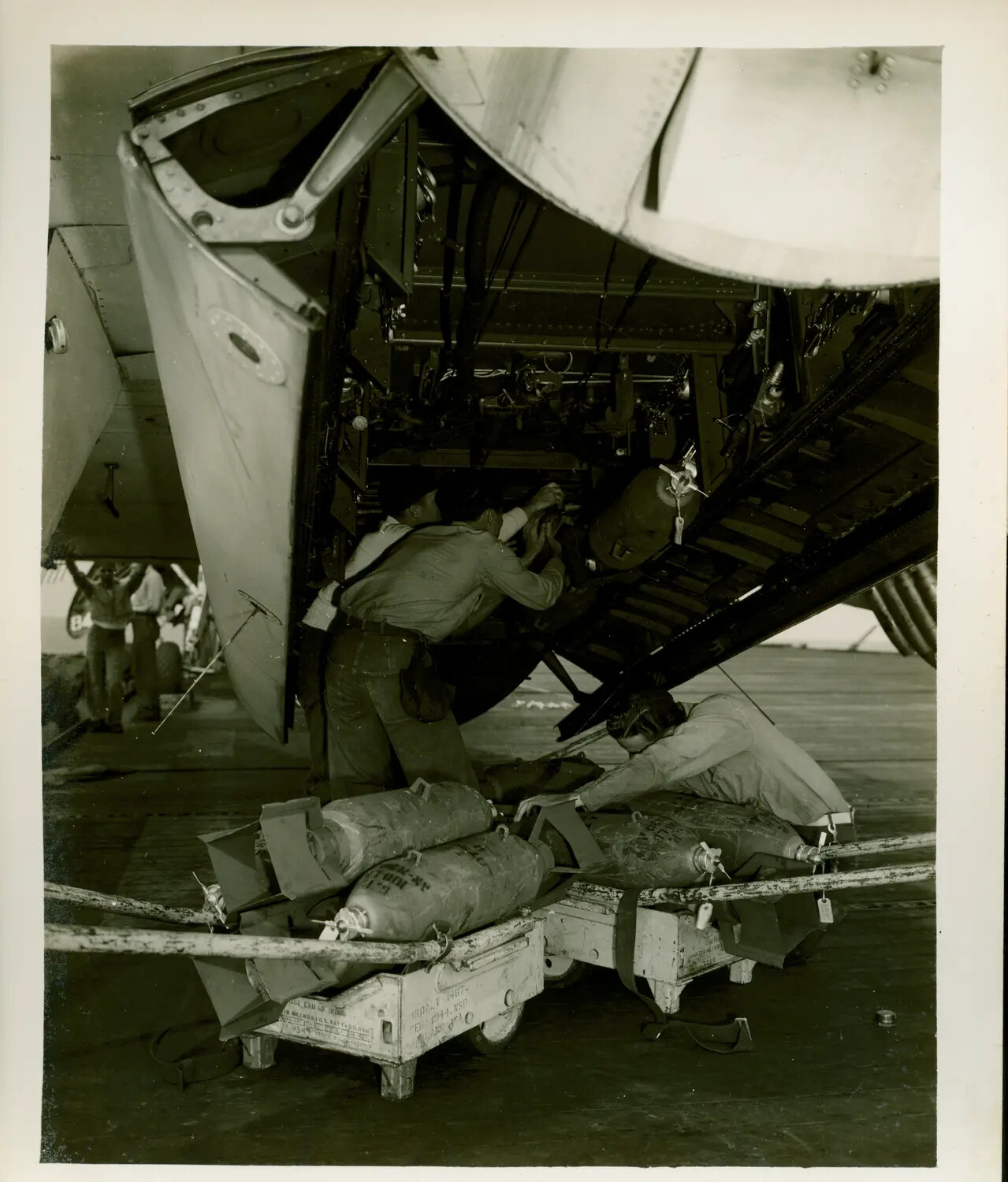 Ordnance Crew Loading Bombs Aboard USS Petrof Bay (CVE-80), WWII Pacific Theater