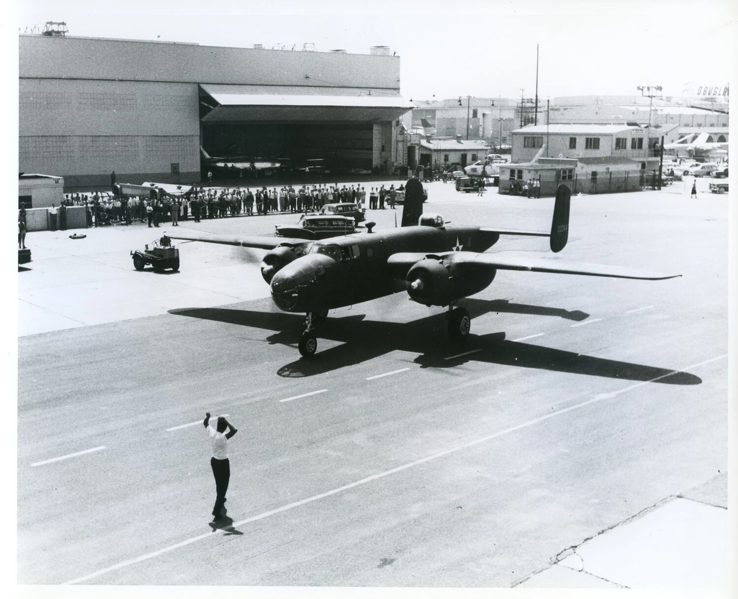 North American B-25 Mitchell Bomber Taxiing Past Crowd at Aircraft Facility
