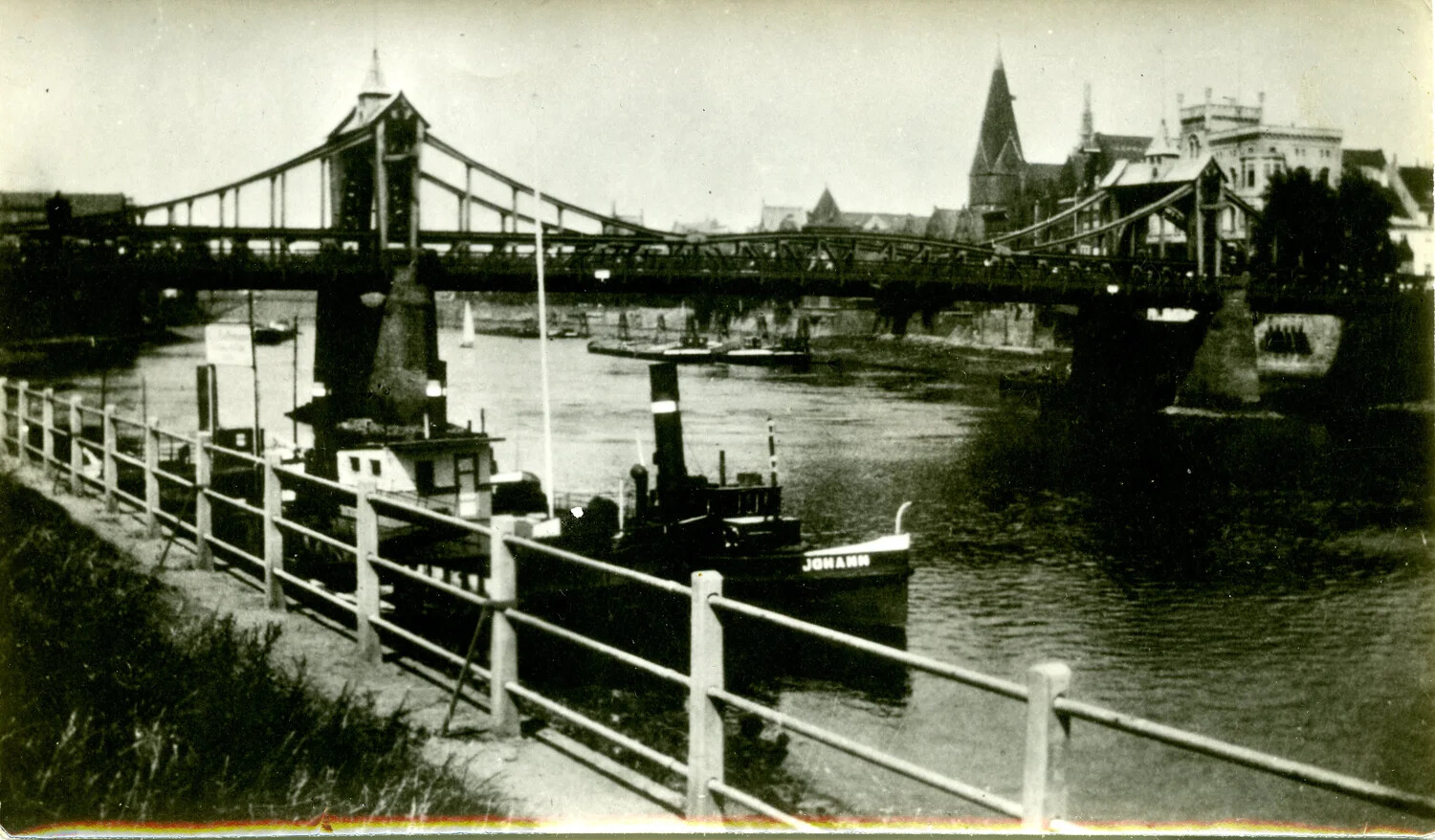 Steam Tug "JOHANN" Moored on River with Truss Bridge and Church Spire, Germany, WWII Era
