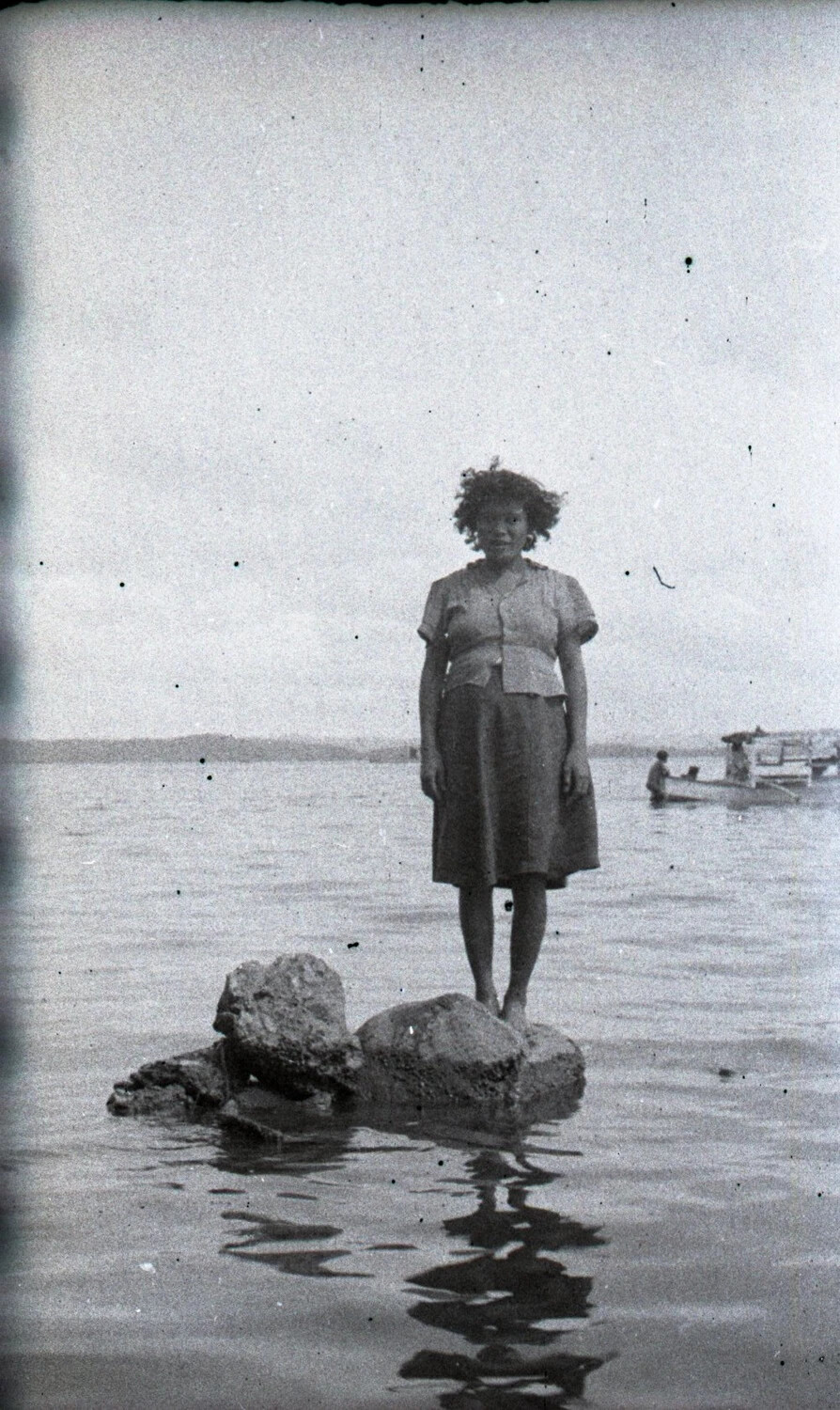 Young Woman Standing on Rocks in Shallow Water, Luzon, Philippines, WWII Era