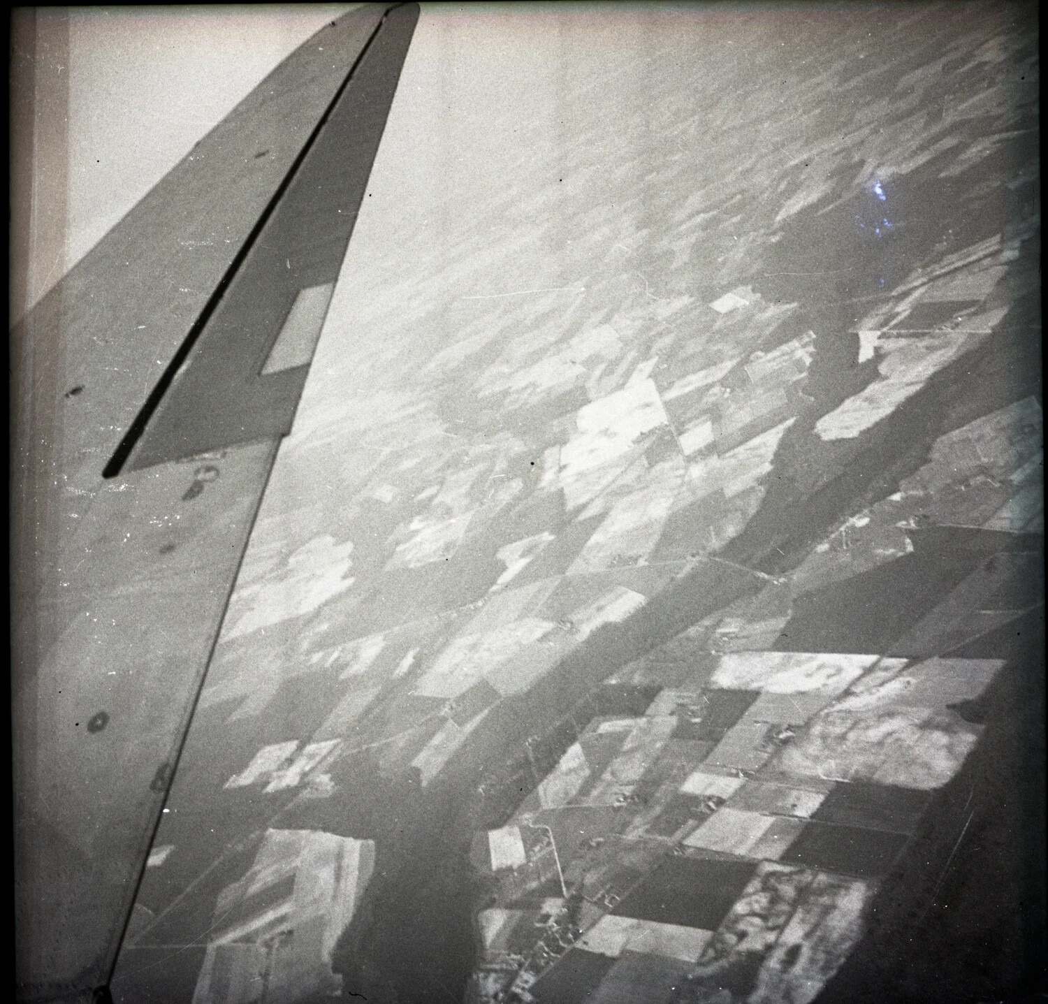 Aerial View from Aircraft Showing Wing/Tail Surface Over Farmland (Misfiled Negative)