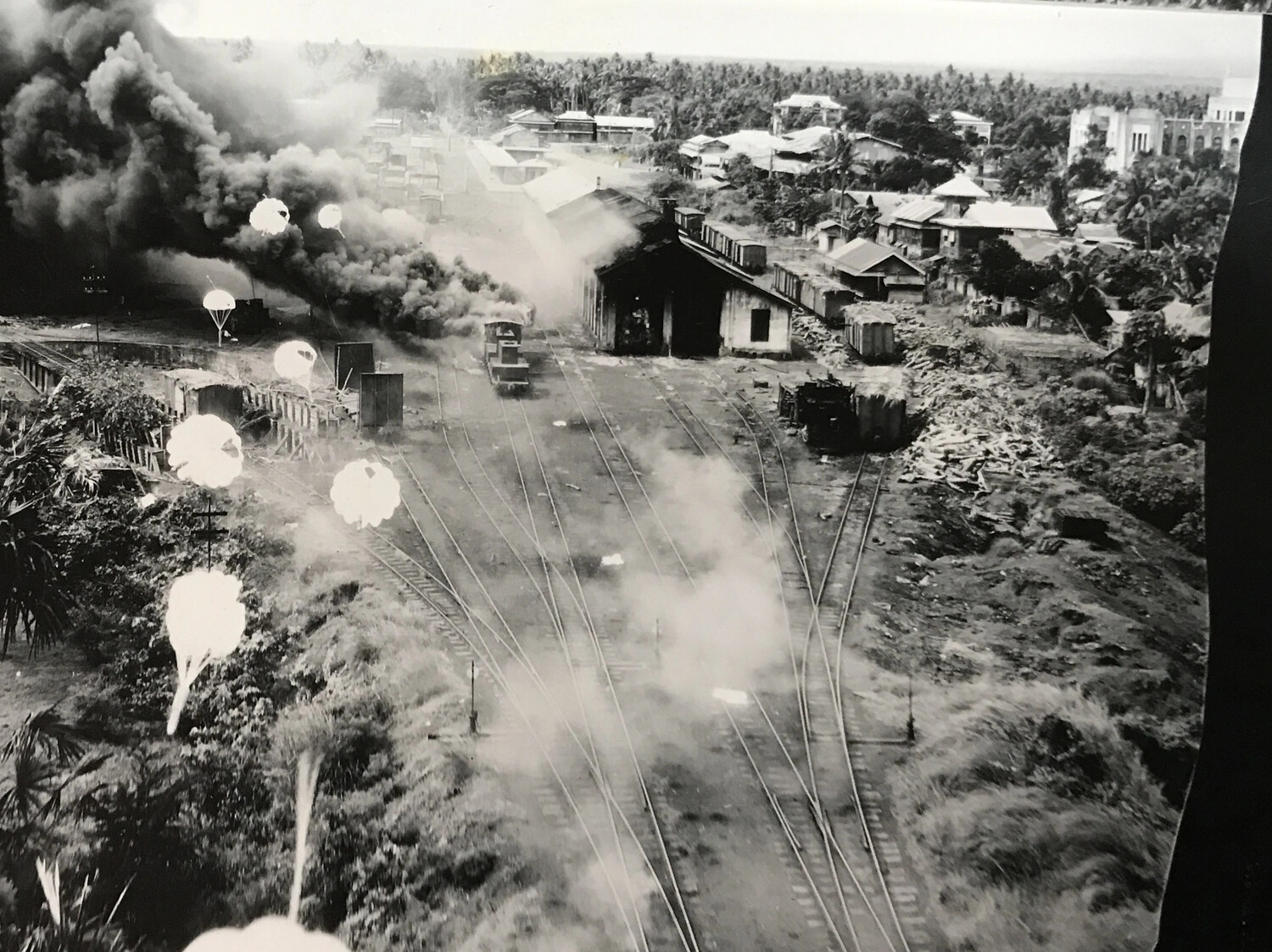 Low-Level Strike Photograph of Rail Yard Under Parafrag Attack with Locomotive, Philippines, 312th Bomb Group