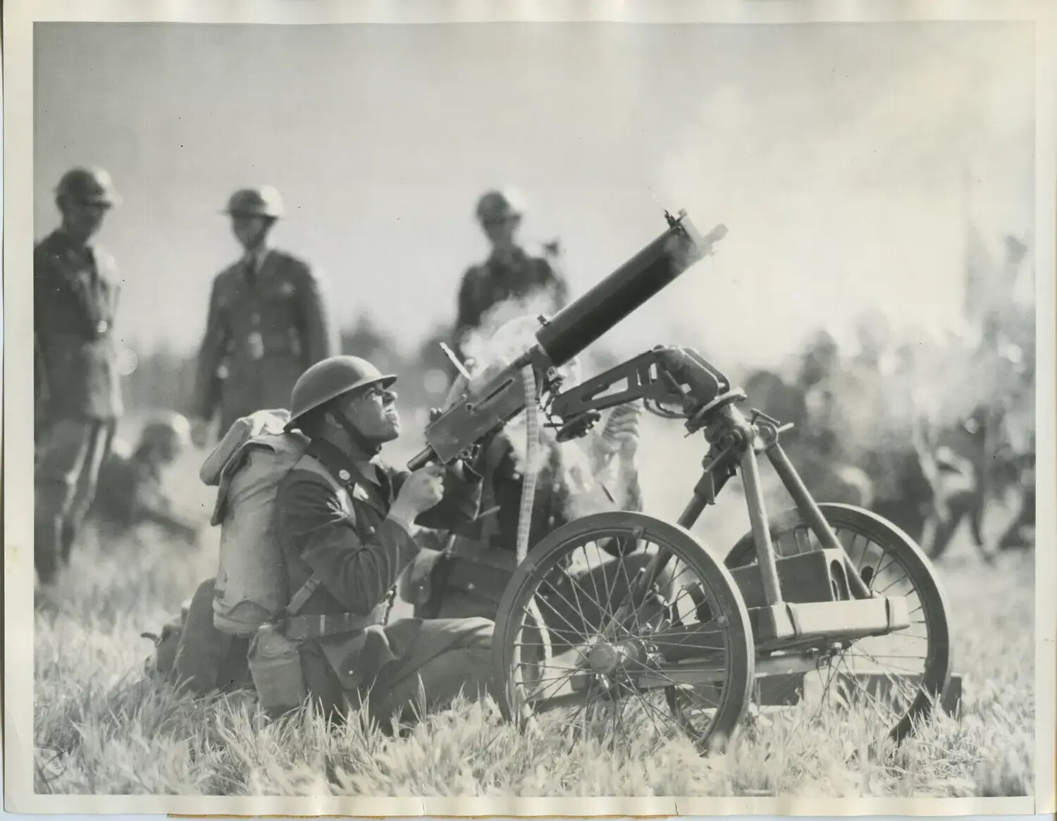 Soldier Firing Machine Gun from Wheeled Anti-Aircraft Mount During Training Demonstration