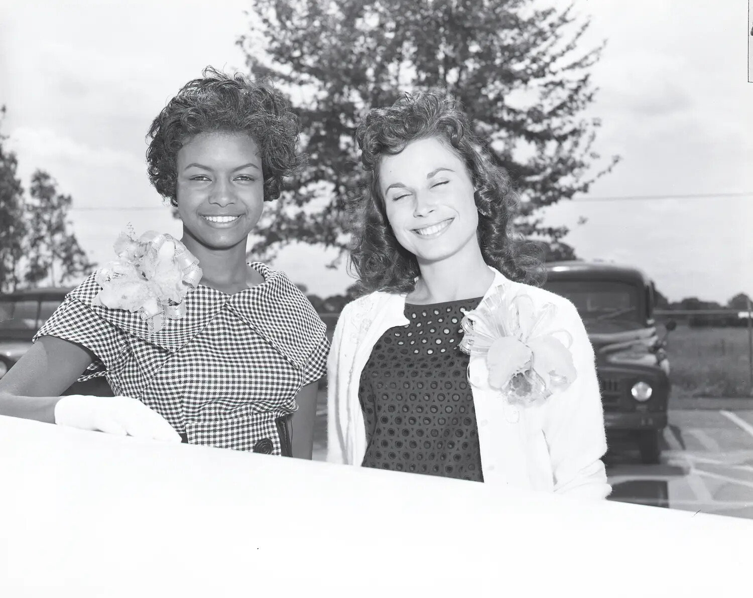 Candid Portrait of Two Young Women with Corsages Outside Air National Guard Facility