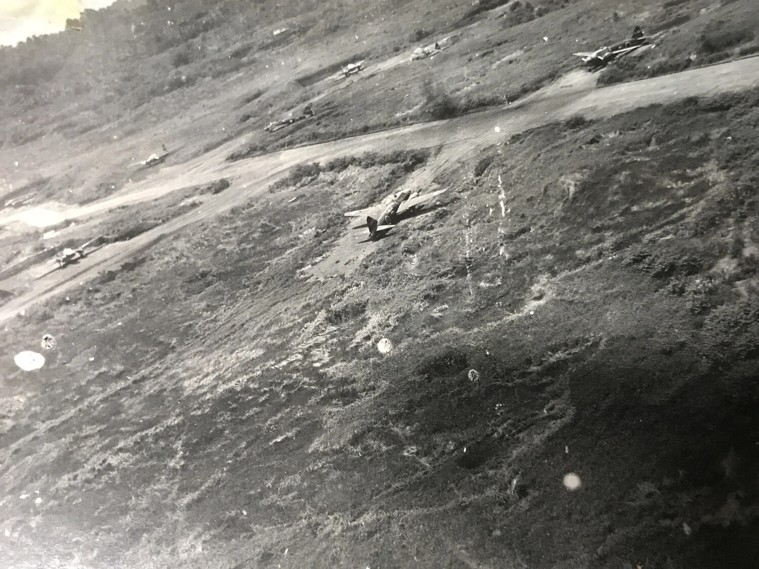 Low-Level Oblique Photograph of Japanese Fighter Aircraft Dispersed on Airfield