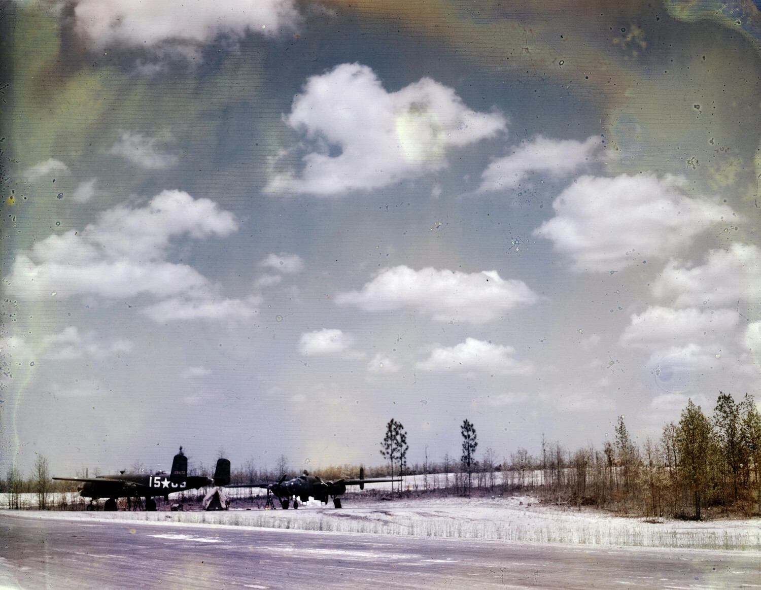 B-25 Mitchell Medium Bombers on Snow-Dusted Airfield, WWII Era (Damaged Color Negative)
