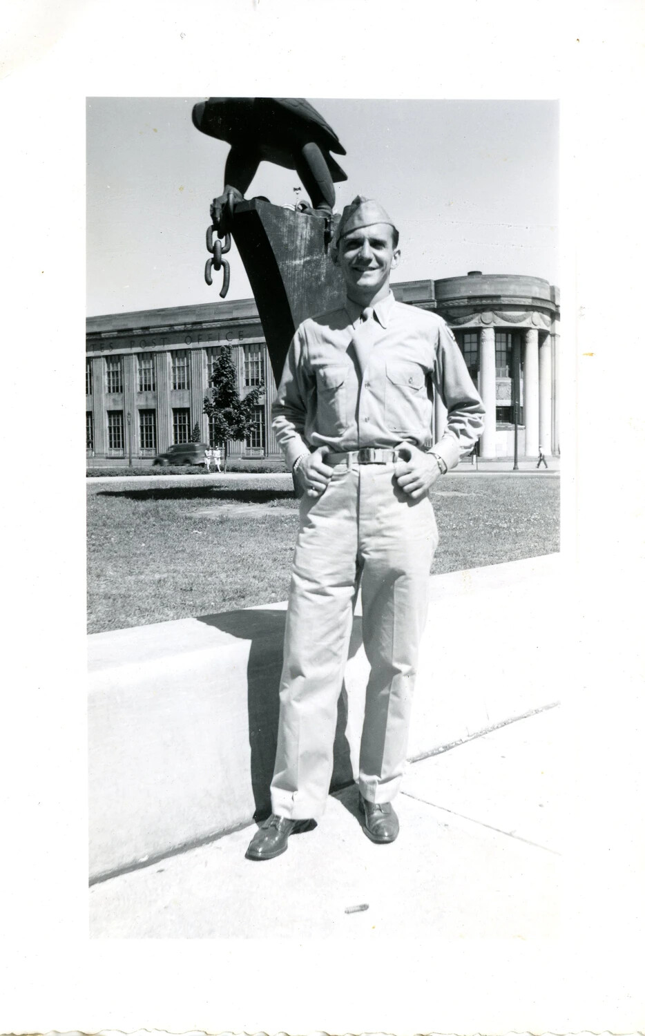 Serviceman Posing by Eagle-and-Anchor Monument in Front of U.S. Post Office, WWII Era