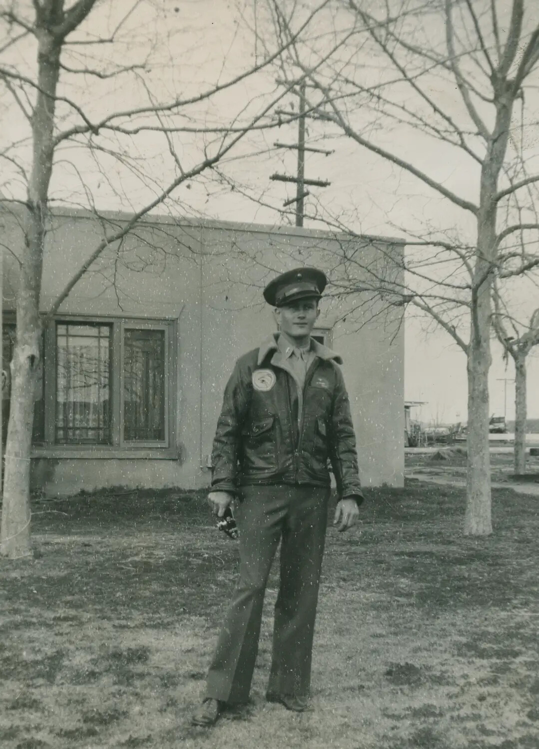 Airman in A-2 Flight Jacket with Squadron Patch, Outside Base Building