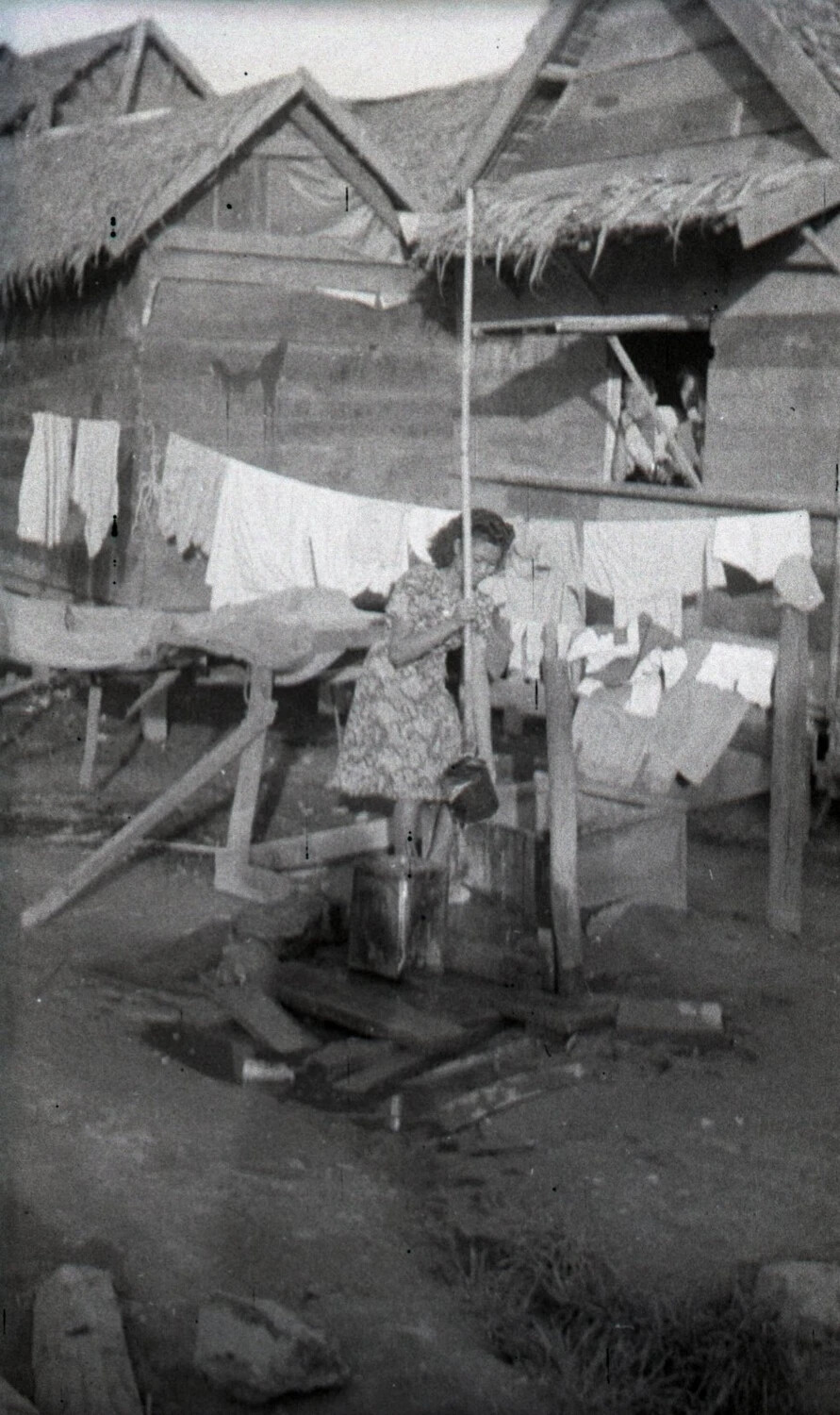 Woman Drawing Water at Outdoor Well, Rural Philippine Barrio, World War II Era