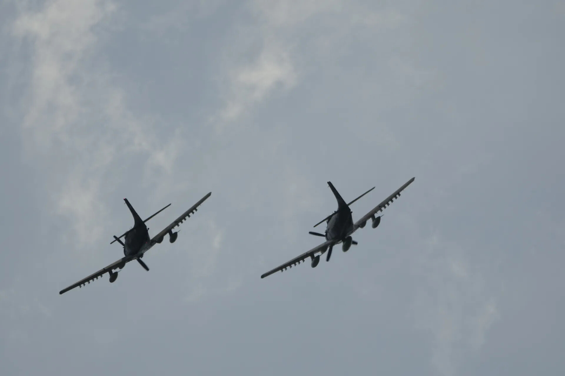 Two Radial-Engine Warbirds (Likely A-1 Skyraider Type) in Formation Flight, Underside View
