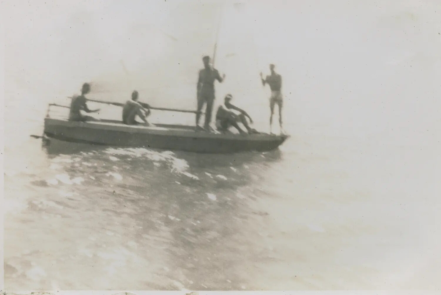 Men Fishing from a Small Boat, Silhouetted Against Bright Sky