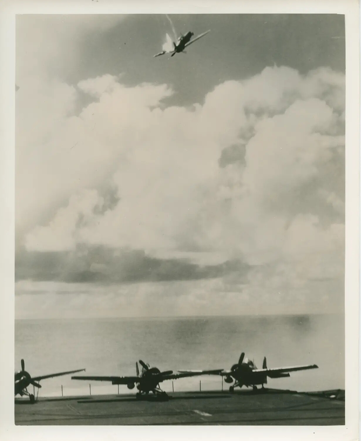Aircraft Struck by Anti-Aircraft Fire Overhead, Photographed from Flight Deck of USS Petrof Bay (CVE-80), World War II