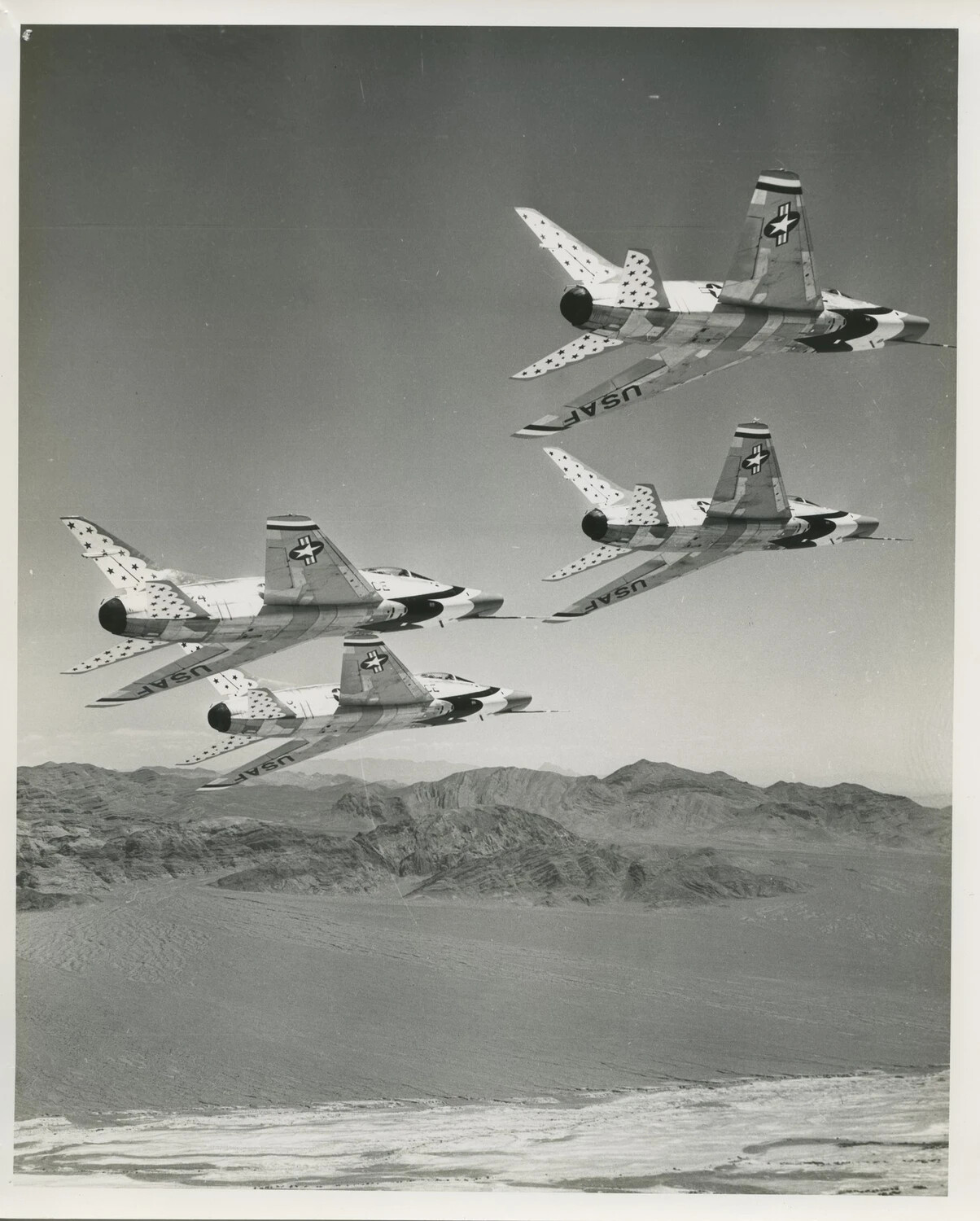 USAF Thunderbirds F-100 Super Sabres Banking in Diamond Formation, Underside View