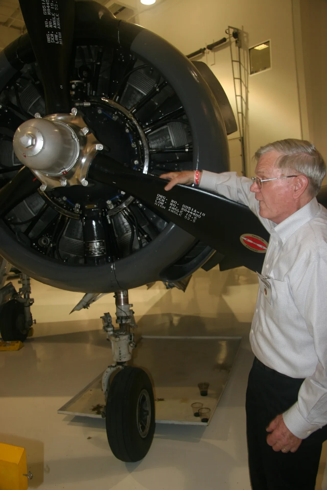 Visitor Examines Radial Engine and Propeller of a Preserved A-1 Skyraider (Museum Display)