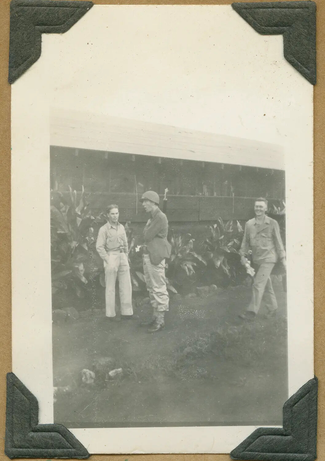 Three Soldiers Beside Barracks Building, One in Helmet and Field Gear, Hawaii, WWII Era