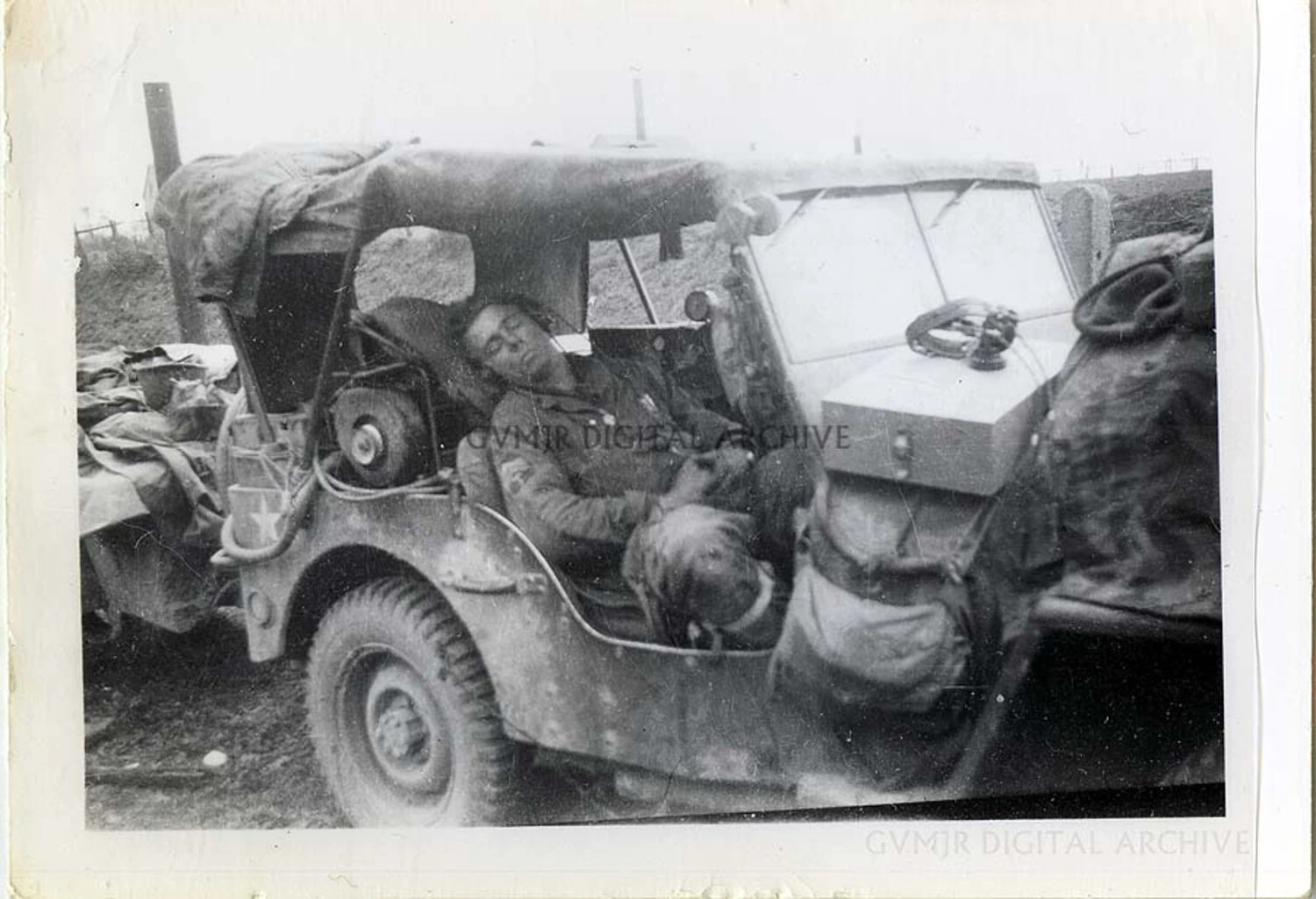 Exhausted Soldier Asleep in Jeep with Dog, 101st Airborne Division, WWII