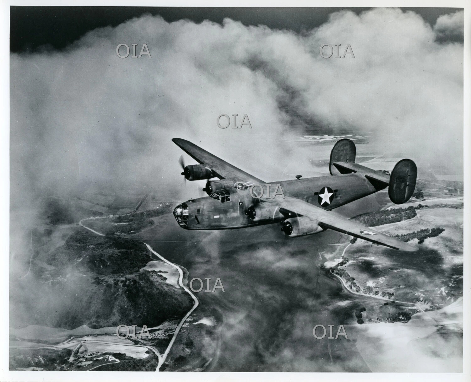Consolidated B-24 Liberator Heavy Bomber in Flight Over Coastal Terrain