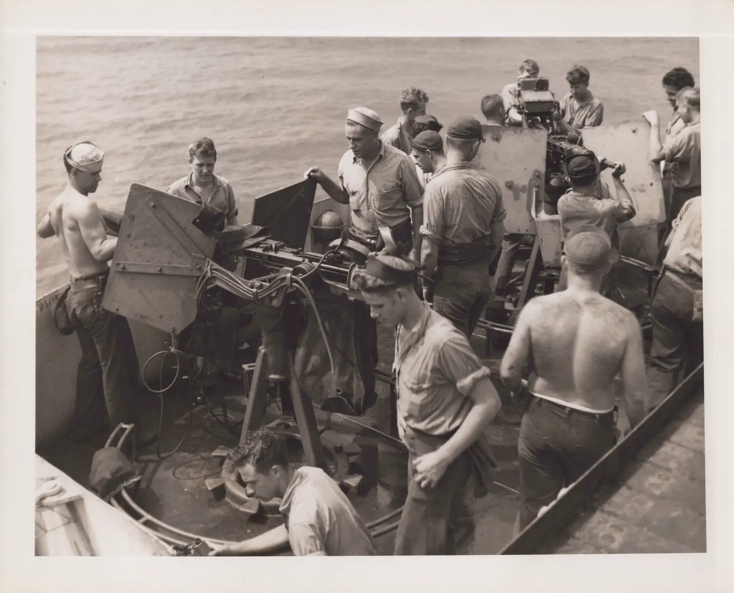 Gunner's Mates Checking 20mm Guns After FM-2 Crash, USS Petrof Bay (CVE-80), 18 December 1944