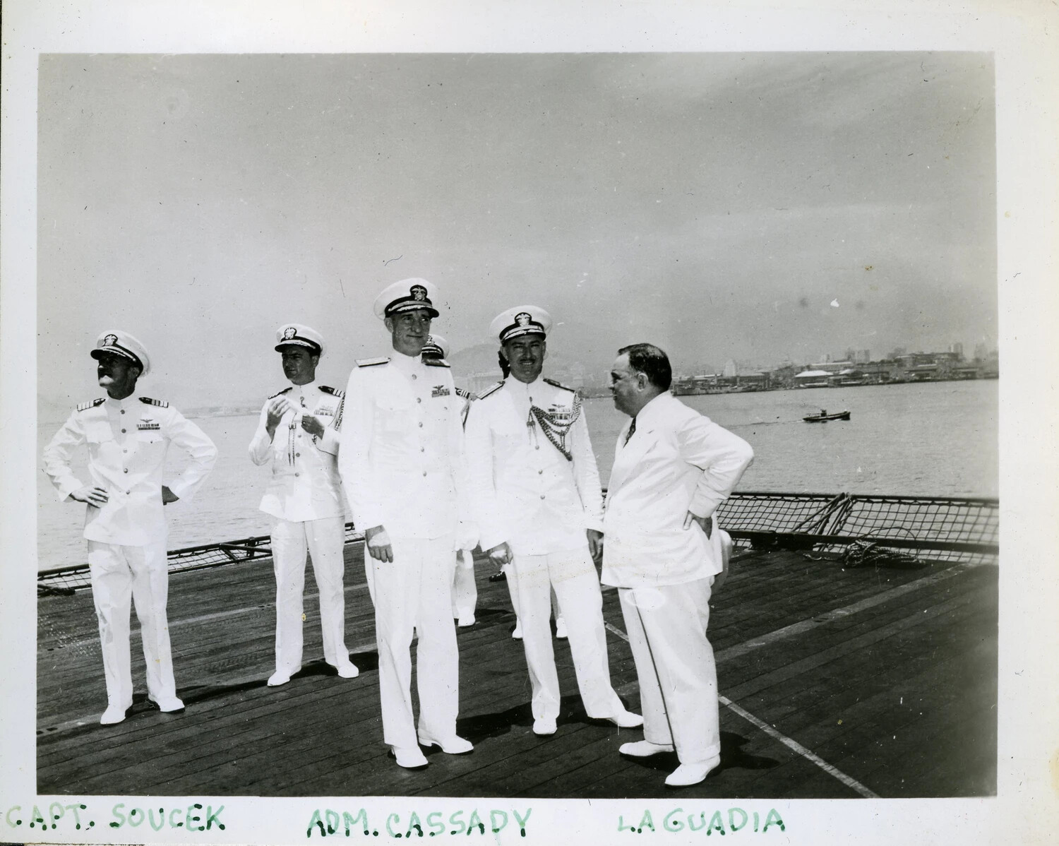Officers and Dignitary Aboard USS Franklin D. Roosevelt (CVB-42) in Foreign Harbor, Identified as Capt. Soucek, Adm. Cassady, and LaGuardia